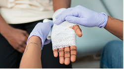 Person falling on a wet floor, representing bodily injury coverage.